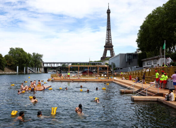 Parisians and visitors swimming near the Eiffel Tower.