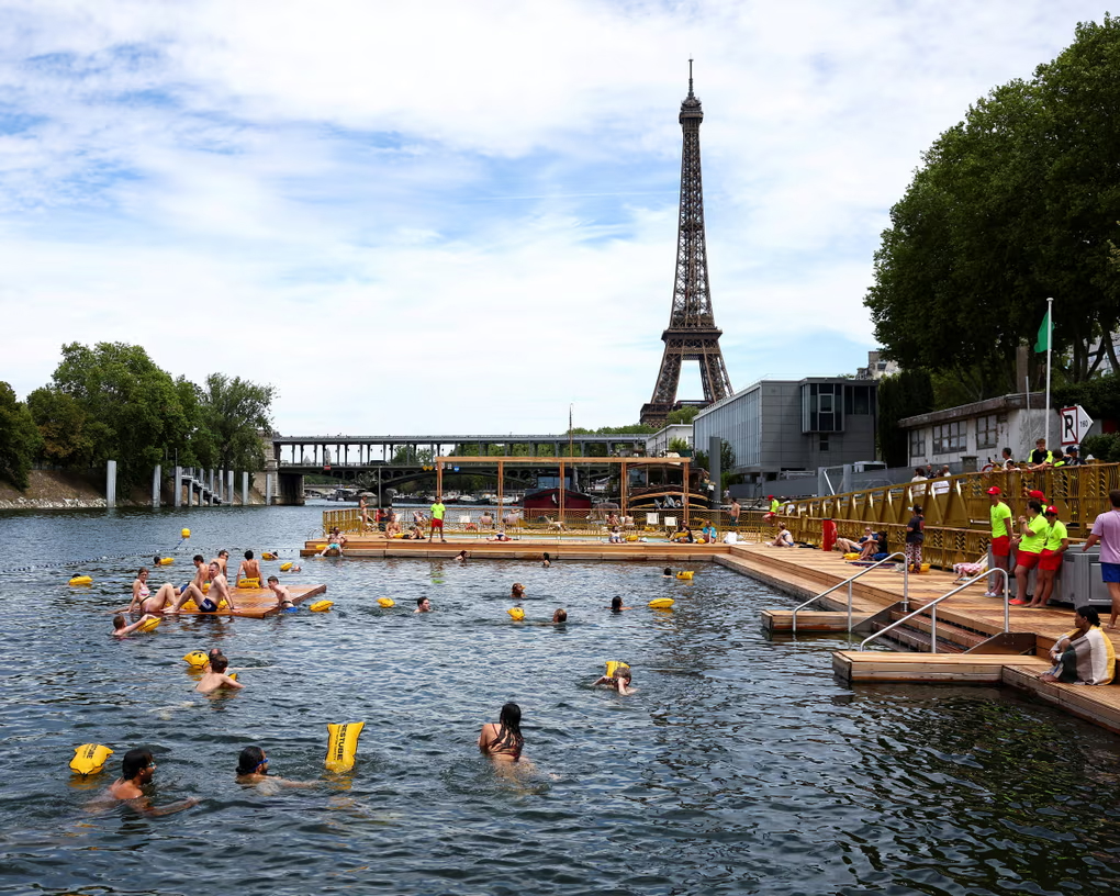 Parisians and visitors swimming near the Eiffel Tower.